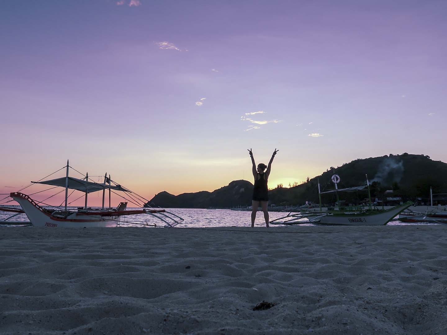 Sunset from white beach in Mararison Island