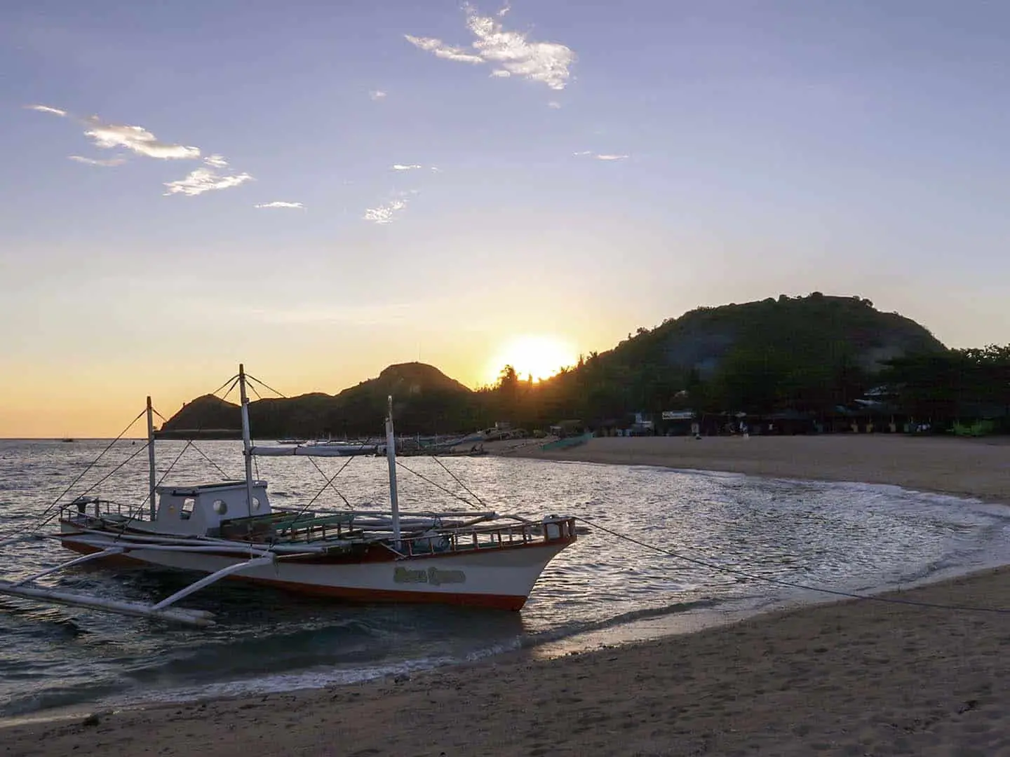Sunset from white beach in Mararison Island