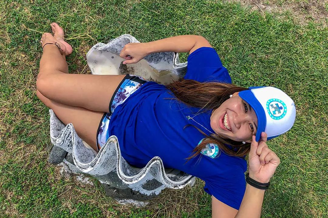 Human sitting in giant clam shell