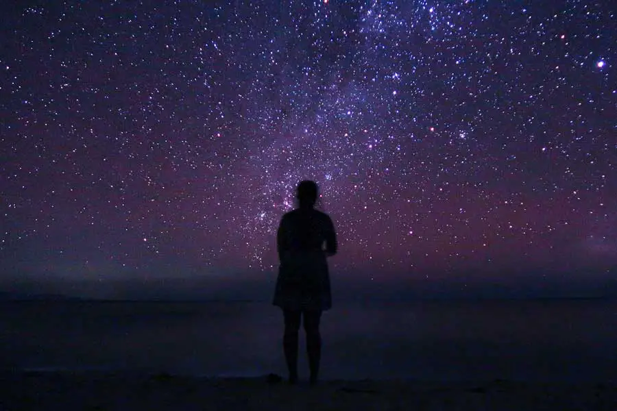 girl ocean stargazing at night