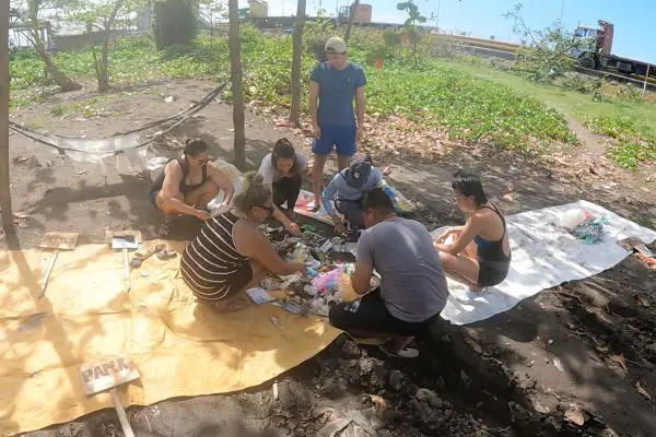 volunteers sorting trash during the beach cleanup